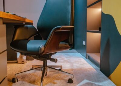 High-back office chair at a desk in a private workspace.