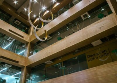 Office atrium with hanging sculptures and Etiqa signage.