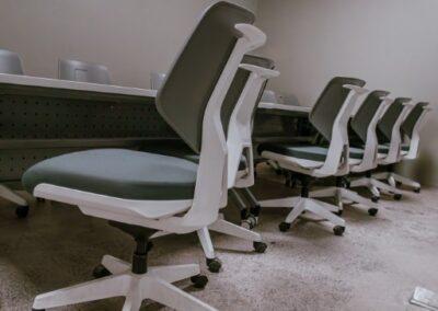 Training room with long desk and rolling chairs.
